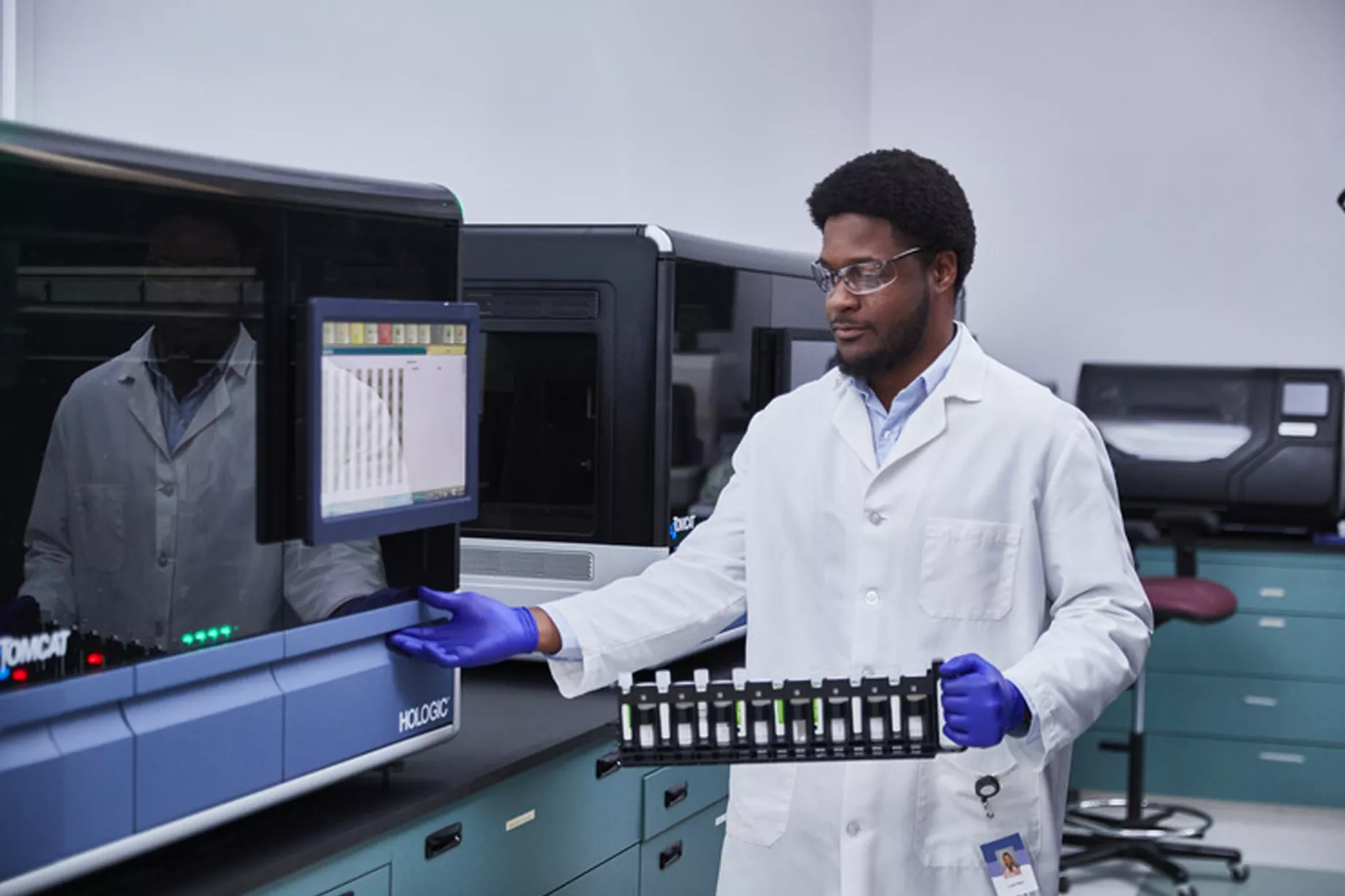 Physician with rack of tubes in lab setting